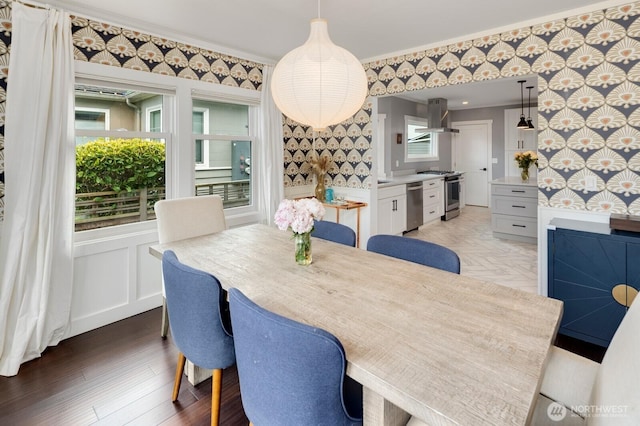 3249 27th Ave W, Seattle, WA 98199 - dining space featuring wallpapered walls, crown molding, and light wood-style floors