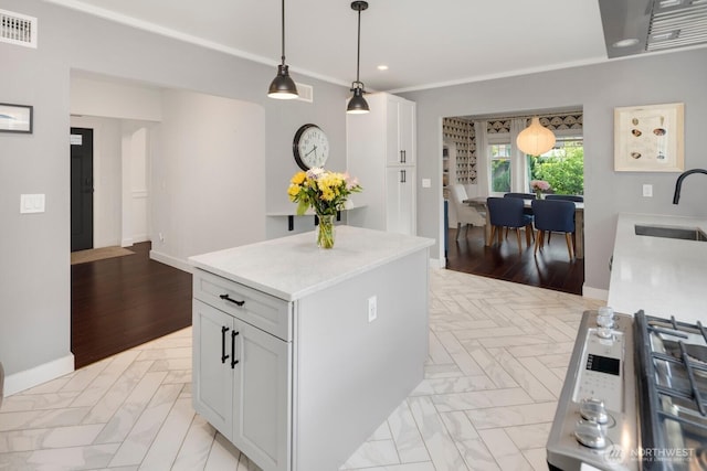3249 27th Ave W, Seattle, WA 98199 - kitchen featuring light countertops, recessed lighting, pendant lighting, white cabinetry, and a kitchen island