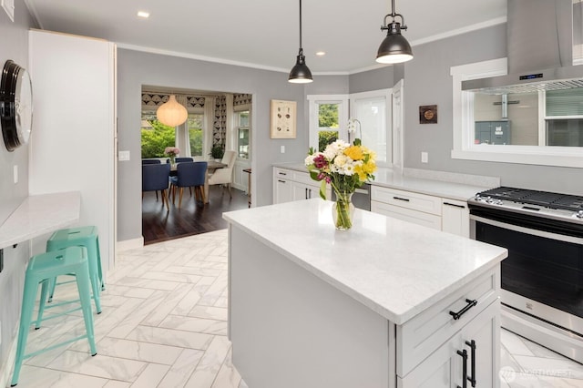 3249 27th Ave W, Seattle, WA 98199 - kitchen featuring wall chimney range hood, gas range, healthy amount of natural light, a kitchen island, and recessed lighting