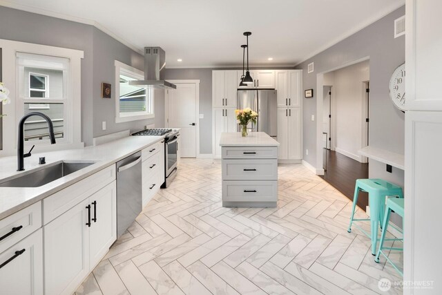 3249 27th Ave W, Seattle, WA 98199 - kitchen with island range hood, appliances with stainless steel finishes, light countertops, crown molding, and recessed lighting