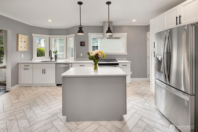 3249 27th Ave W, Seattle, WA 98199 - kitchen featuring appliances with stainless steel finishes, wall chimney range hood, light countertops, light marble finish floors, and white cabinets