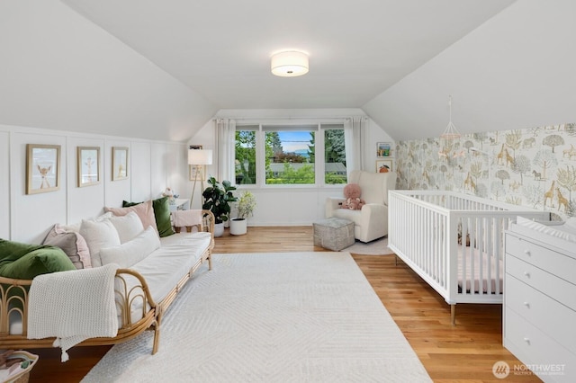 3249 27th Ave W, Seattle, WA 98199 - bedroom with wood finished floors, lofted ceiling, and wallpapered walls