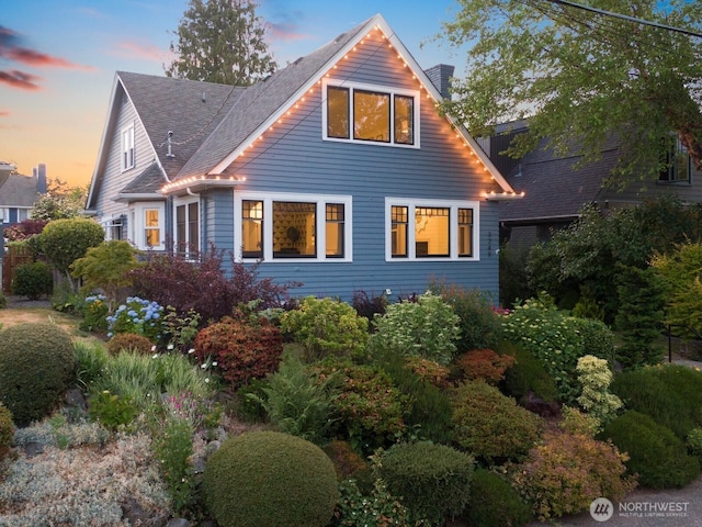 3249 27th Ave W, Seattle, WA 98199 - property exterior at dusk featuring roof with shingles and a chimney