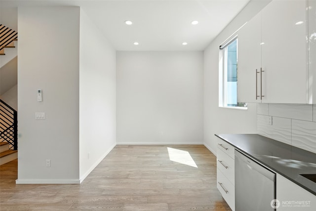 9732 Woodlawn Ave N Unit A, Seattle, WA 98103 - unfurnished dining area with stairs, light wood finished floors, and recessed lighting
