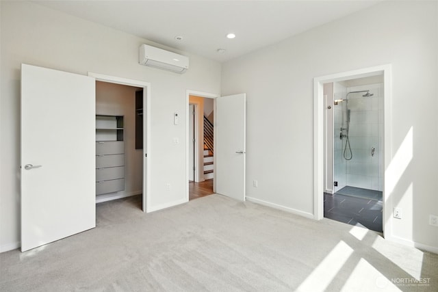 9732 Woodlawn Ave N Unit A, Seattle, WA 98103 - unfurnished bedroom featuring a wall mounted AC, carpet, a spacious closet, ensuite bathroom, and a closet