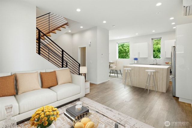 9732 Woodlawn Ave N Unit A, Seattle, WA 98103 - living room with light wood-style floors, stairs, and recessed lighting