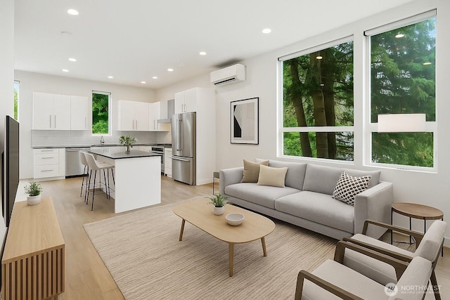 9732 Woodlawn Ave N Unit A, Seattle, WA 98103 - living room featuring a wall mounted air conditioner, healthy amount of natural light, light wood-type flooring, and recessed lighting