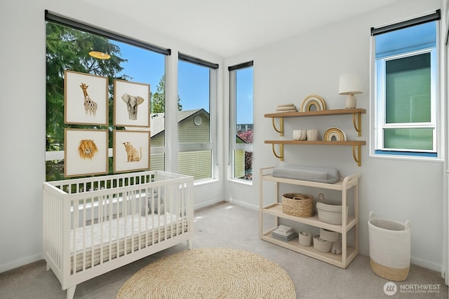 9732 Woodlawn Ave N Unit A, Seattle, WA 98103 - carpeted bedroom featuring multiple windows and a crib