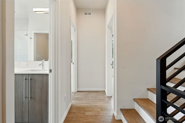 9732 Woodlawn Ave N Unit A, Seattle, WA 98103 - corridor featuring stairs and light wood finished floors