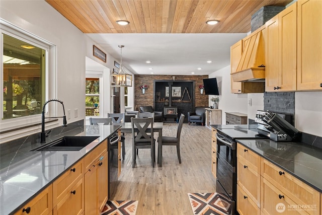 330 Swauk Creek Ln, Cle Elum, WA 98922 - kitchen featuring black appliances, light wood-style floors, open floor plan, custom exhaust hood, and light brown cabinets