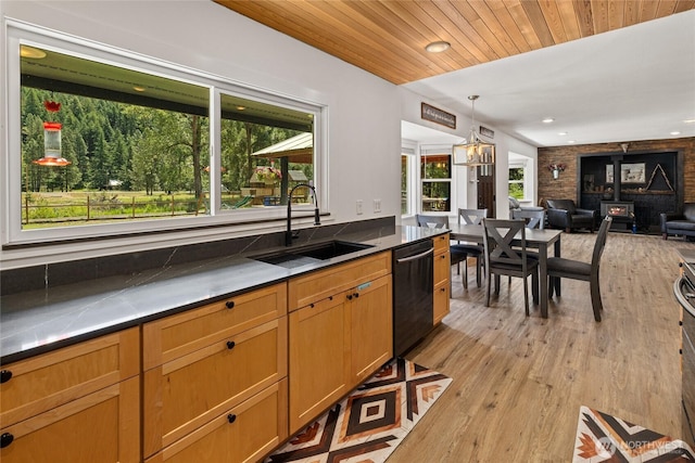 330 Swauk Creek Ln, Cle Elum, WA 98922 - kitchen with dishwashing machine, light wood finished floors, decorative light fixtures, open floor plan, and brown cabinets