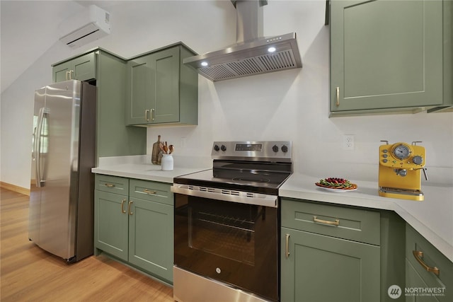 10405 Tahoma Dr, Anderson Island, WA 98303 - kitchen featuring green cabinets, appliances with stainless steel finishes, wall chimney exhaust hood, and a wall unit AC