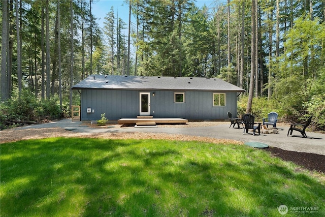 10405 Tahoma Dr, Anderson Island, WA 98303 - back of house with a yard, an outdoor fire pit, and a forest view