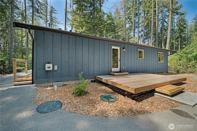 10405 Tahoma Dr, Anderson Island, WA 98303 - view of front of property featuring board and batten siding and a wooden deck