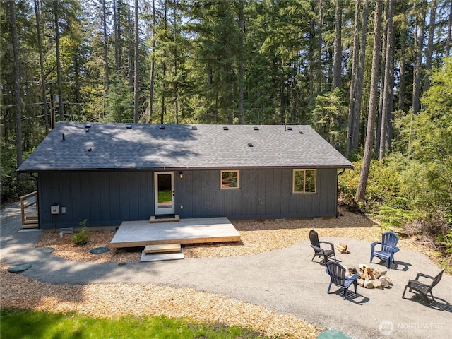 10405 Tahoma Dr, Anderson Island, WA 98303 - back of property with an outdoor fire pit, a patio area, a view of trees, and a deck
