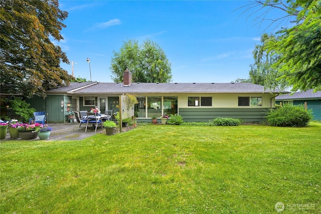 2714 Alderwood Ave, Bellingham, WA 98225 - rear view of property featuring a chimney, a patio area, and a lawn