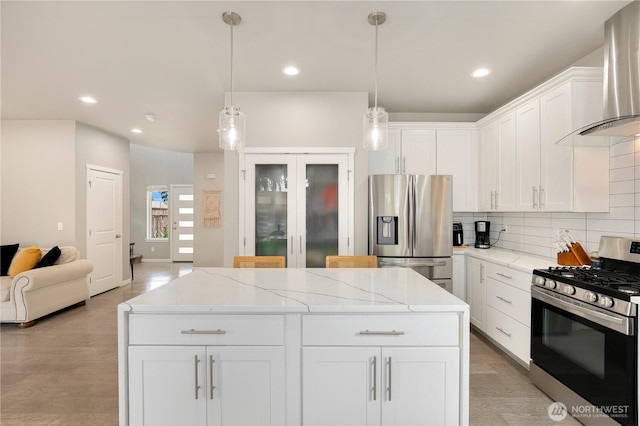 8438 Tacoma Ave S, Tacoma, WA 98444 - kitchen featuring stainless steel appliances, wall chimney exhaust hood, tasteful backsplash, a center island, and white cabinetry