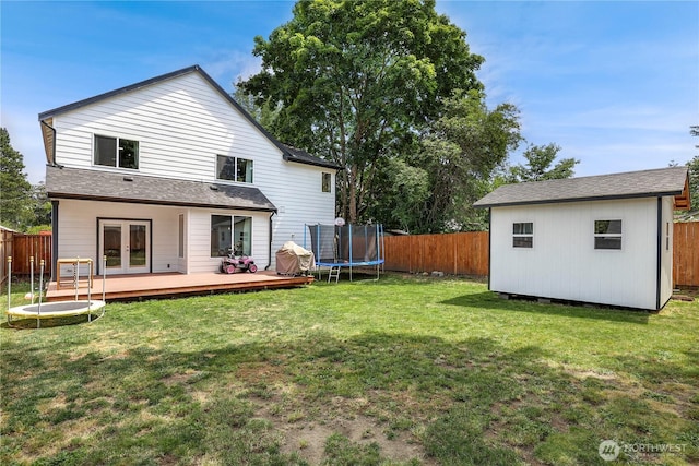 8438 Tacoma Ave S, Tacoma, WA 98444 - rear view of house with a trampoline, french doors, a deck, and a fenced backyard