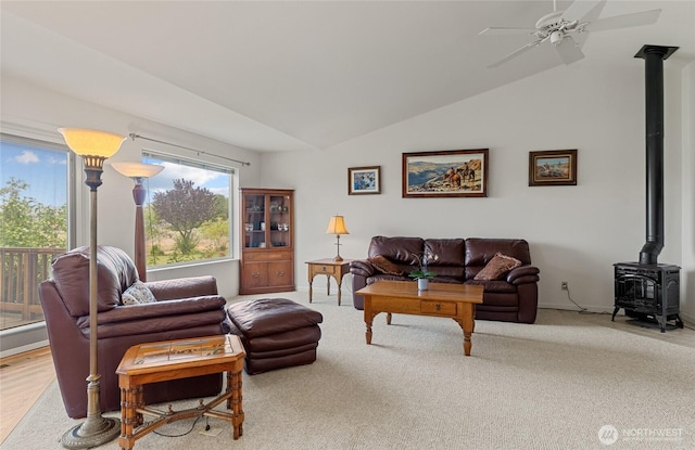 19627 Rd A NE, Soap Lake, WA 98851 - carpeted living area with a wood stove, lofted ceiling, and ceiling fan