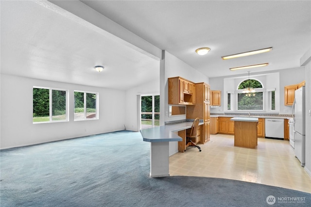 4030 Twin Creek Rd, Ferndale, WA 98248 - kitchen with white dishwasher, a kitchen island, freestanding refrigerator, open floor plan, and light countertops