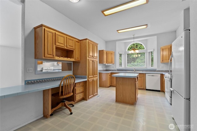 4030 Twin Creek Rd, Ferndale, WA 98248 - kitchen featuring white appliances, built in study area, light floors, a kitchen island, and light countertops