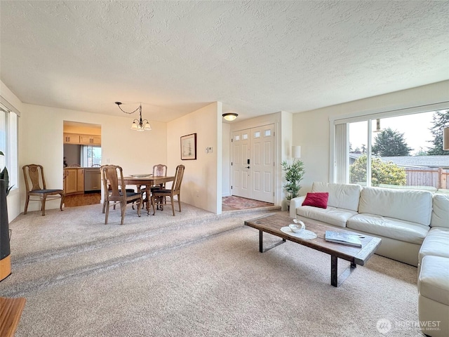 1521 W 13th St, Port Angeles, WA 98363 - living area featuring a textured ceiling, a chandelier, and light colored carpet