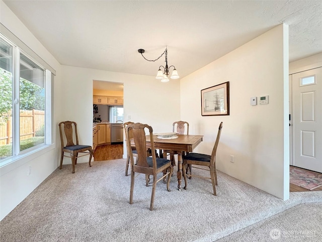 1521 W 13th St, Port Angeles, WA 98363 - dining area with light carpet and a chandelier