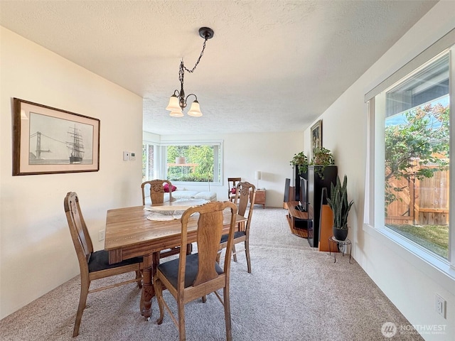 1521 W 13th St, Port Angeles, WA 98363 - dining space featuring carpet, a textured ceiling, and a chandelier