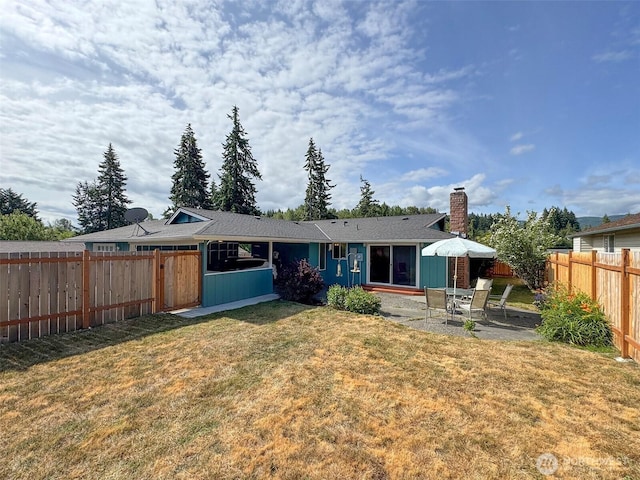 1521 W 13th St, Port Angeles, WA 98363 - rear view of property featuring a chimney, a fenced backyard, a patio area, and board and batten siding