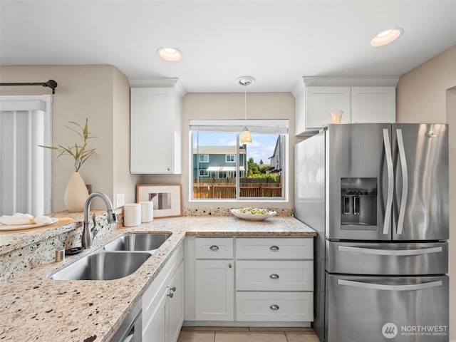 535 Blanchat Ct, Enumclaw, WA 98022 - kitchen with stainless steel fridge with ice dispenser, white cabinets, light stone countertops, pendant lighting, and recessed lighting