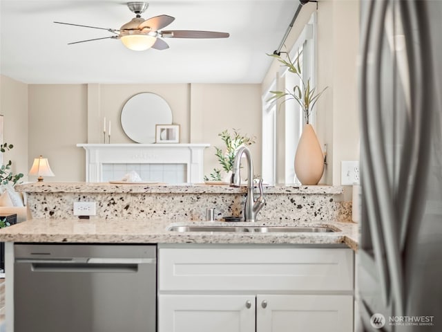 535 Blanchat Ct, Enumclaw, WA 98022 - kitchen featuring appliances with stainless steel finishes, a ceiling fan, light stone countertops, and white cabinets