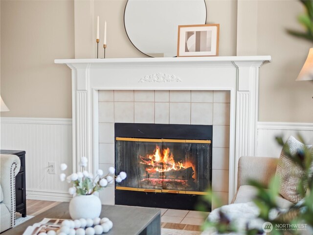 535 Blanchat Ct, Enumclaw, WA 98022 - detailed view of a tile fireplace, a wainscoted wall, and wood finished floors