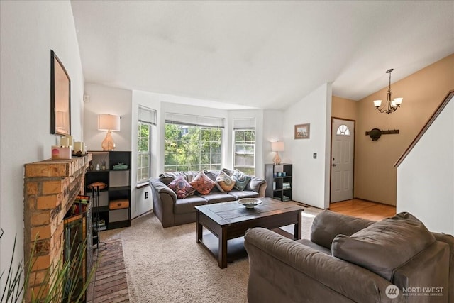 13319 15th Avenue Ct E, Tacoma, WA 98445 - living area with vaulted ceiling, a chandelier, and a stone fireplace