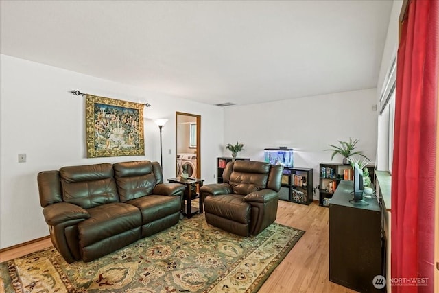 13319 15th Avenue Ct E, Tacoma, WA 98445 - living area featuring washer / clothes dryer and light wood-style flooring