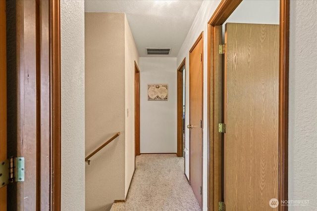 13319 15th Avenue Ct E, Tacoma, WA 98445 - hallway featuring light carpet, a textured wall, and an upstairs landing