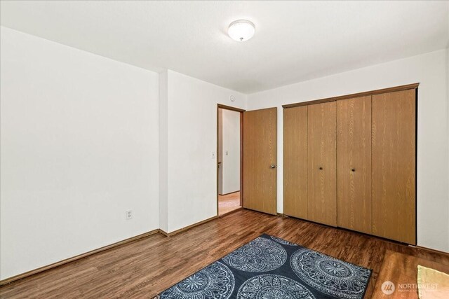 13319 15th Avenue Ct E, Tacoma, WA 98445 - unfurnished bedroom featuring wood finished floors and a closet