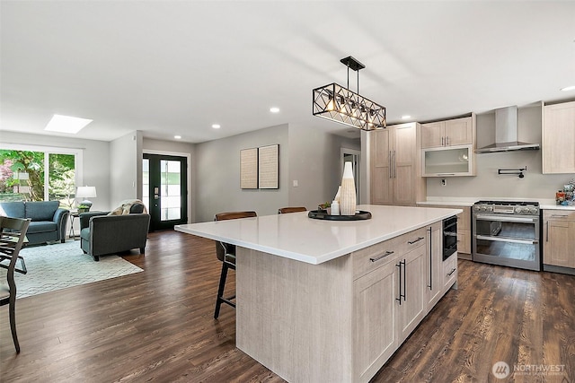 22526 251st Ave SE, Maple Valley, WA 98038 - kitchen featuring wall chimney exhaust hood, range with two ovens, recessed lighting, a skylight, and light countertops