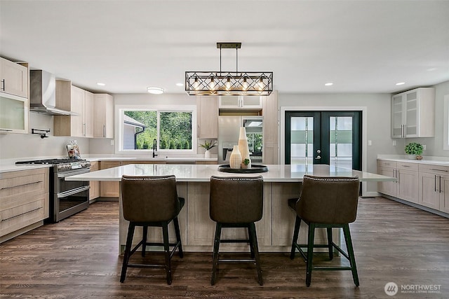 22526 251st Ave SE, Maple Valley, WA 98038 - kitchen with wall chimney range hood, range with two ovens, light countertops, a center island, and french doors
