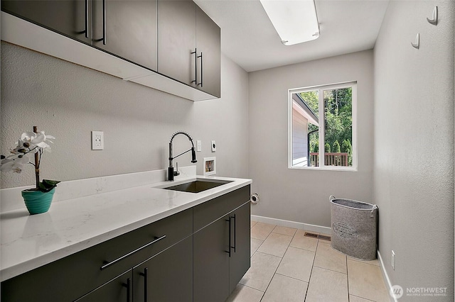 22526 251st Ave SE, Maple Valley, WA 98038 - laundry room featuring cabinet space, hookup for a washing machine, hookup for an electric dryer, and light tile patterned floors