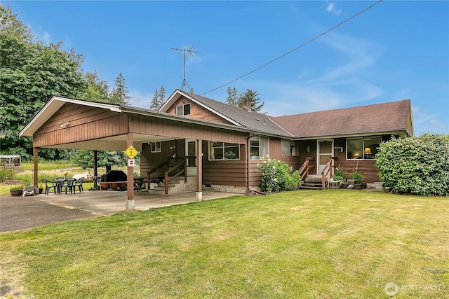 40515 228th Way SE, Enumclaw, WA 98022 - back of property featuring a yard, a shingled roof, a chimney, a carport, and driveway