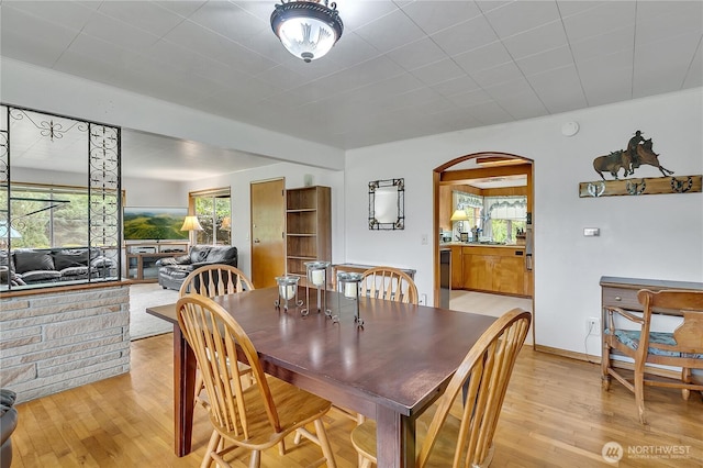 40515 228th Way SE, Enumclaw, WA 98022 - dining area featuring arched walkways and light wood-type flooring