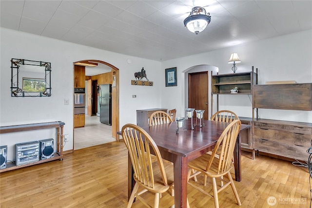 40515 228th Way SE, Enumclaw, WA 98022 - dining area featuring arched walkways and light wood finished floors