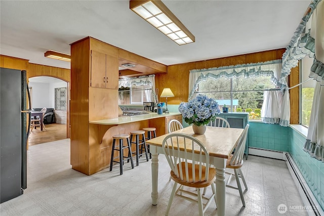 40515 228th Way SE, Enumclaw, WA 98022 - dining area with a baseboard heating unit, arched walkways, plenty of natural light, and wooden walls
