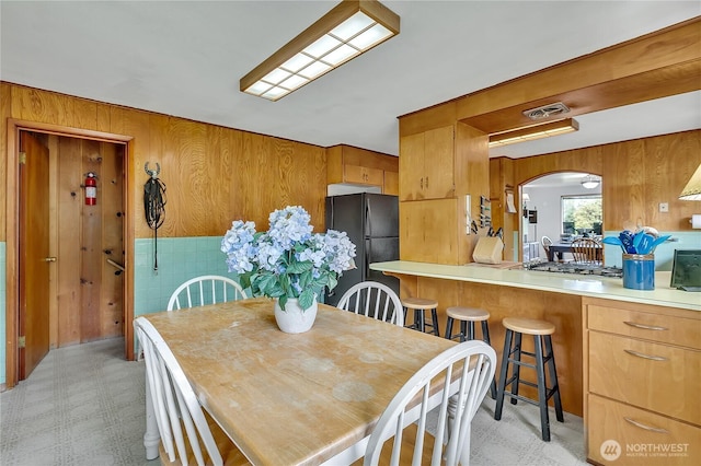 40515 228th Way SE, Enumclaw, WA 98022 - dining room with arched walkways, wooden walls, and light floors