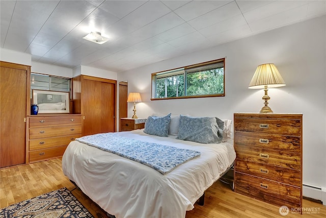 40515 228th Way SE, Enumclaw, WA 98022 - bedroom with light wood-style flooring, a baseboard radiator, and a closet
