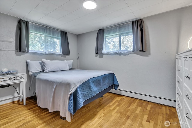 40515 228th Way SE, Enumclaw, WA 98022 - bedroom featuring a baseboard radiator, multiple windows, and light wood-style floors