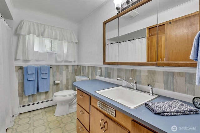 40515 228th Way SE, Enumclaw, WA 98022 - full bath featuring a baseboard heating unit, vanity, tile patterned floors, crown molding, and a wainscoted wall
