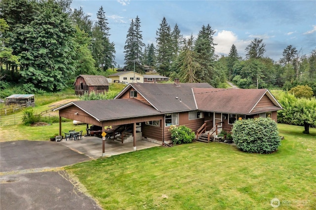 40515 228th Way SE, Enumclaw, WA 98022 - view of front of house with asphalt driveway, a front yard, a carport, and a shingled roof