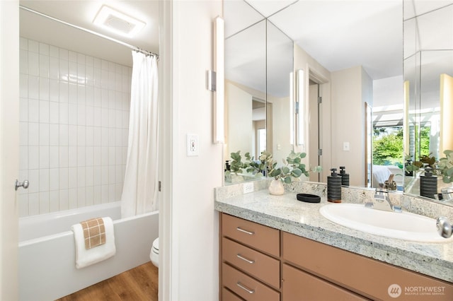 101 NW 58th St Unit 10, Seattle, WA 98107 - bathroom with vanity, shower / bath combo with shower curtain, ensuite bath, and wood finished floors