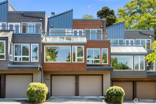 101 NW 58th St Unit 10, Seattle, WA 98107 - back of house with a garage, a balcony, and board and batten siding